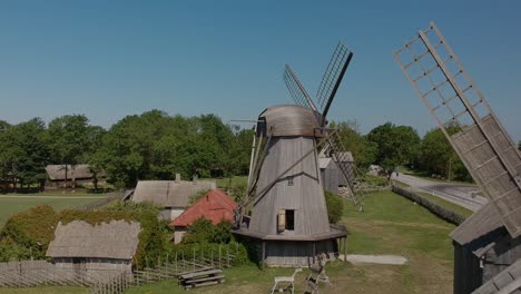 Aerial-shot-of-two-windmills,-flying-backwards-them