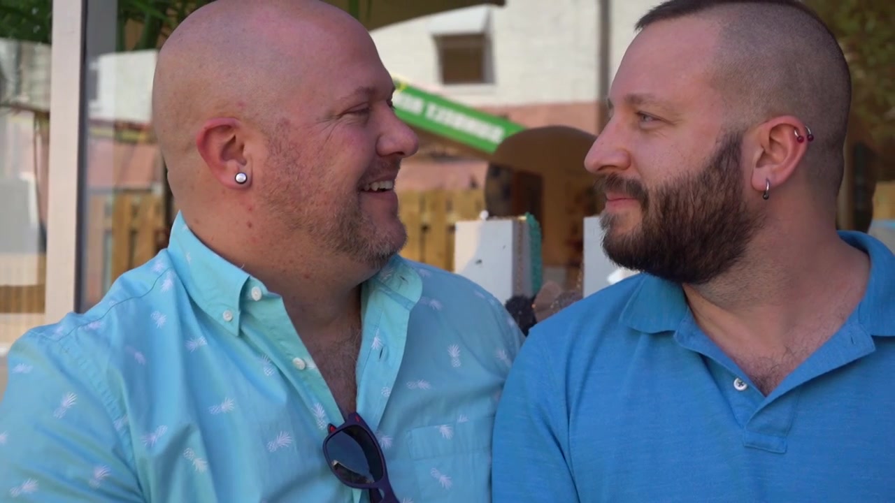 Loving gay male couple sitting and talking