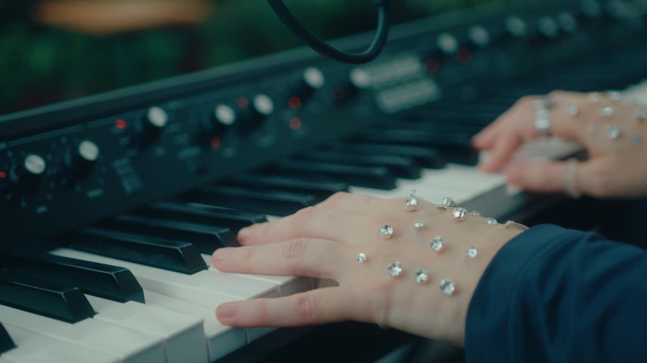 Jeweled Hands of Female Pianist Playing Musical Keyboard