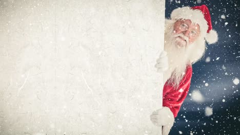 santa claus sosteniendo un cartel combinado con la nieve que cae