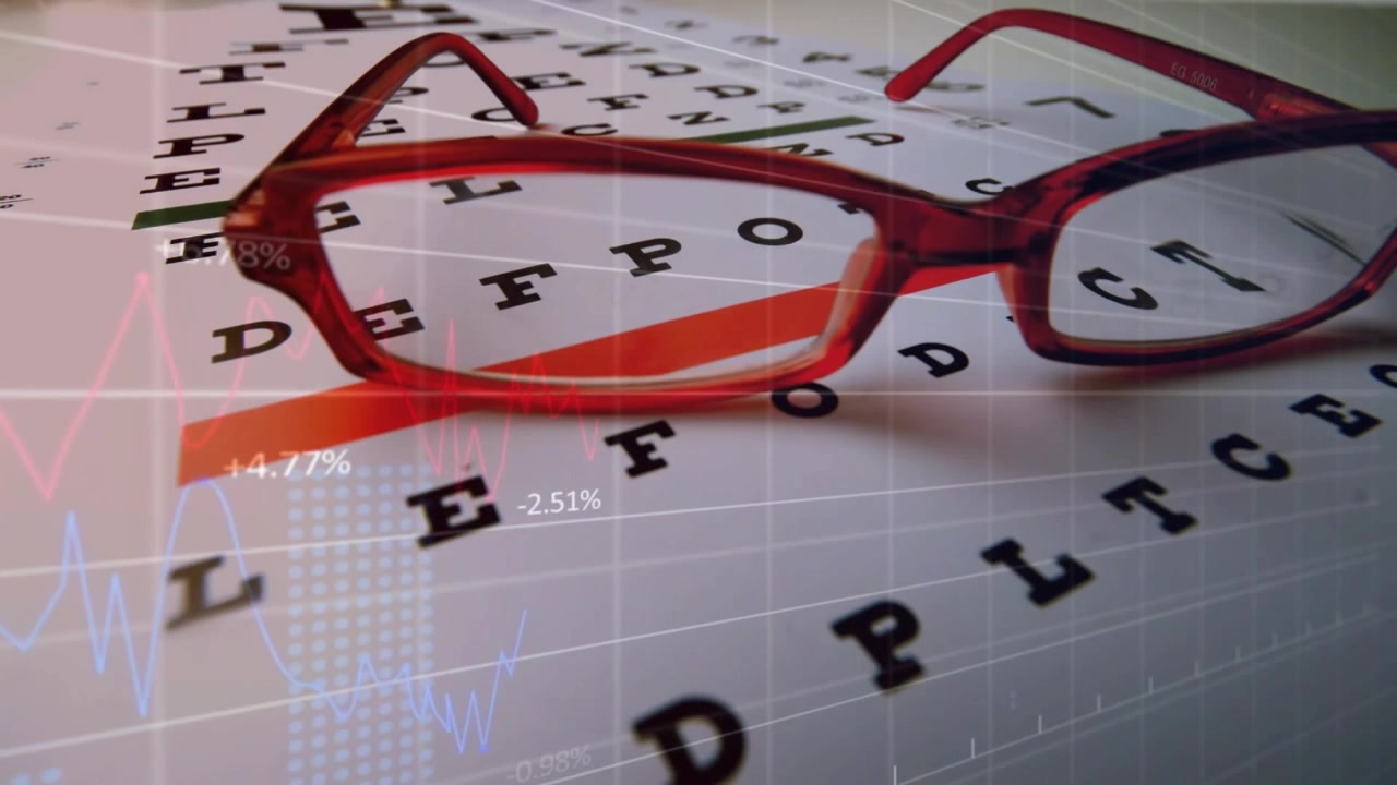 Sliding red-framed eyeglasses revealing magnified letters on printed eye chart, with data overlays