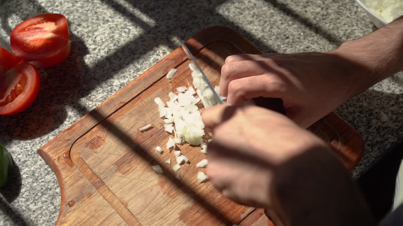 Man Chopping White Onion With Bright Sunlight Passing Through The Window. - high angle