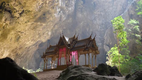 pavilion in phraya nakhon cave with sunbeam, thailand, surrounded by rock walls and trees