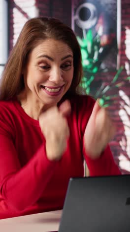 vertical video confident joyous freelancer woman sits at laptop in her loft office