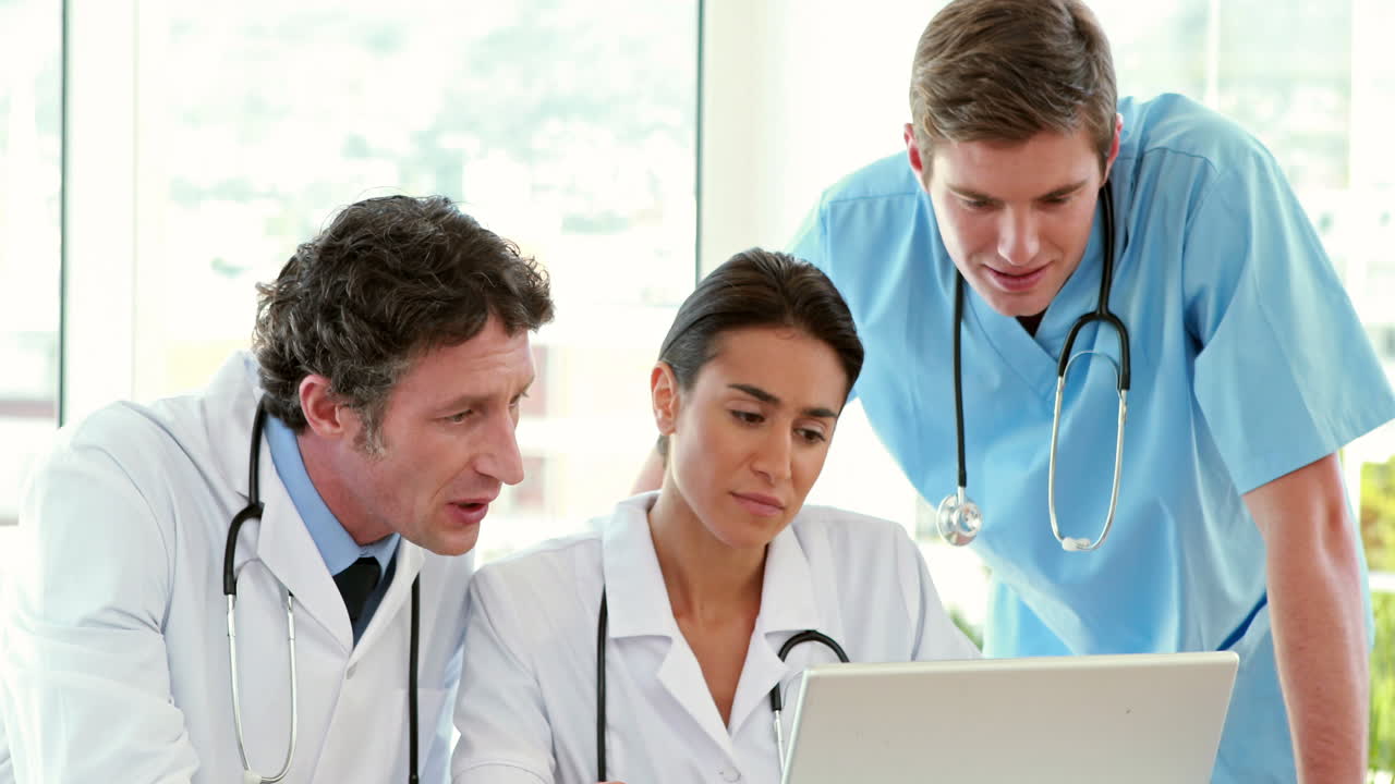 Medical team working on laptop computer 