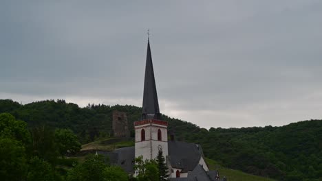 time lapse of a thick cloud cover above a catholic church in klotten, germany