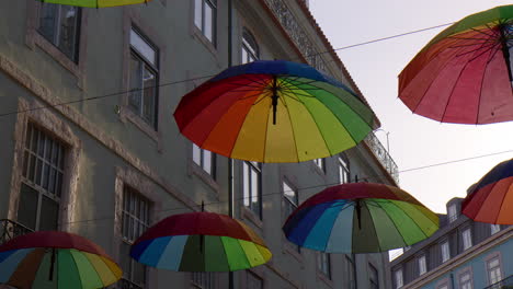 Umbrellas-Float-Above-The-Pink-Streets-In-Lisbon,-Portugal