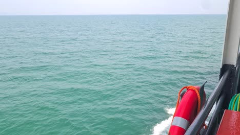 ferry boat sailing in gulf of thailand between islands and mainland, revealing shot