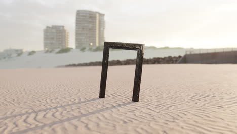 Empty-wooden-picture-frame-on-the-beach-sand