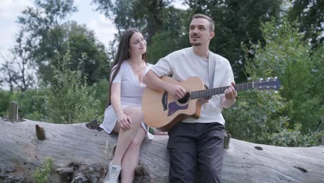 couple with guitar outdoors