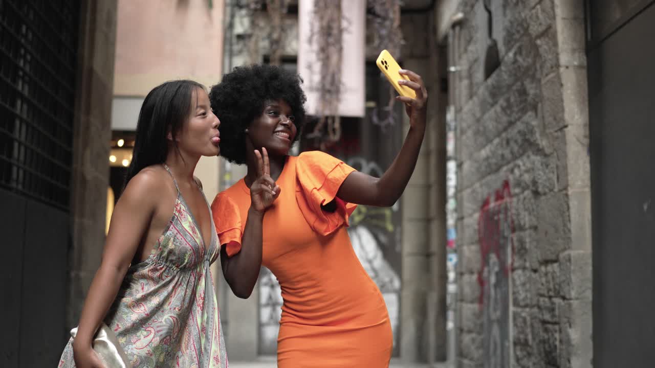Women taking selfies on a city street