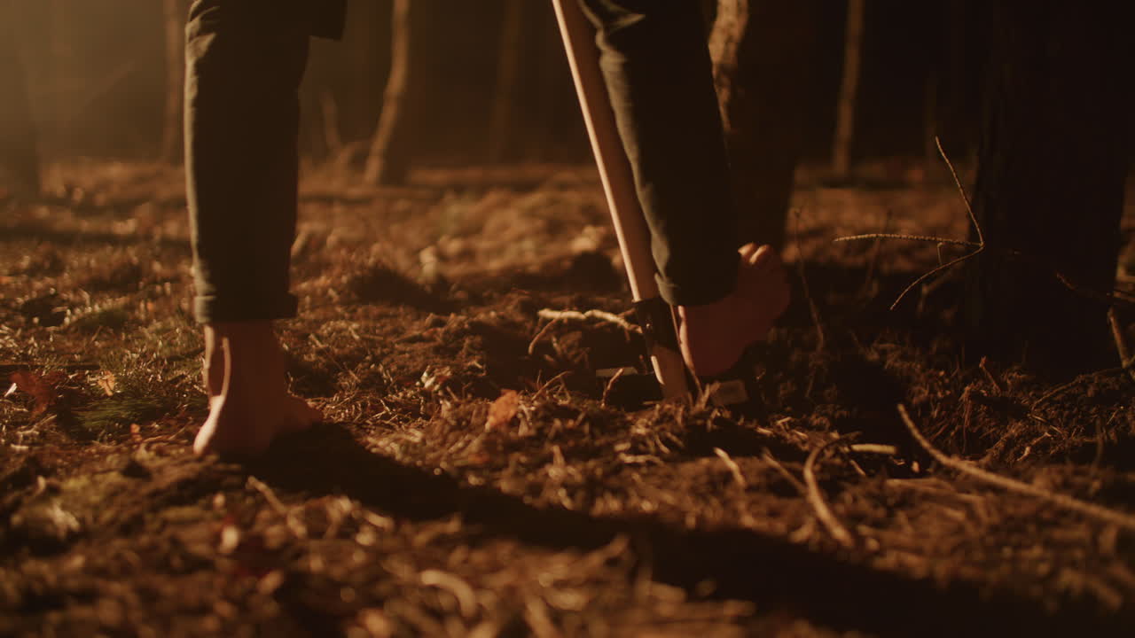 Barefoot digging in the forest at night