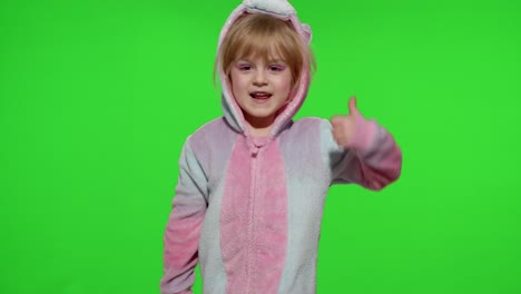 Little-child-girl-smiling,-showing-thumbs-up-gesture,-agree-sign-in-unicorn-pajamas-on-chroma-key