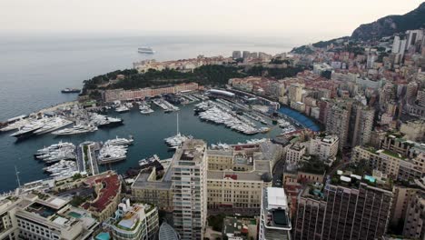 yacht boats in port harbor marina on monaco city coastline, aerial drone view