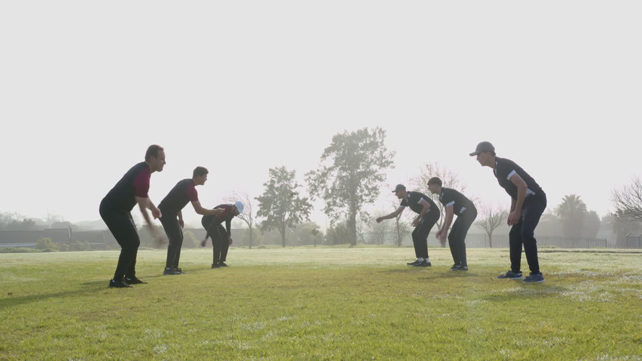 Playing cricket on field, group of boys practicing in morning sunlight