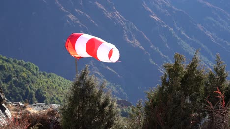 A-windsock-beside-a-helicopter-pad-in-the-mountains-of-Nepal-at-Namche-Bazaar