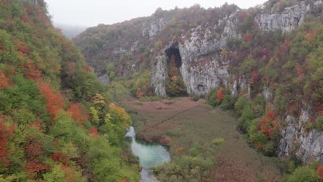 Flying-through-Plitvice-valley-park-during-cloudy-moody-morning,-aerial