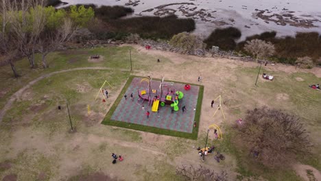 Children-playing-games-with-ship-shaped-toy-in-the-park-of-the-Vicente-Lopez-riverside-area-in-Buenos-Aires