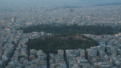 athens skyline with lush hill amidst urban sprawl at dusk