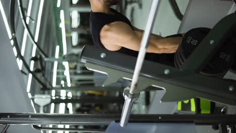 male athlete preparing for intensive workout, loading heavy plates on barbell