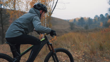 athlete male riding a mountain bike in the countryside