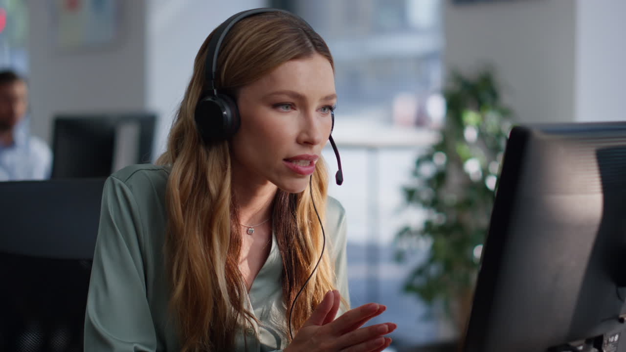 Support specialist talking headset working computer at helpdesk space closeup