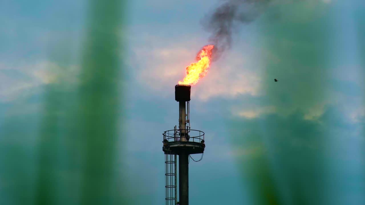 Flame From Chimney, Torch At Oil Field - Low Angle Shot
