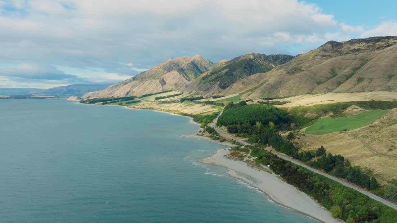 Picturesque aerial drone view of Lake Hawea and turquoise water with rugged mountain ranges in Otago region of New Zealand's Aotearoa South Island