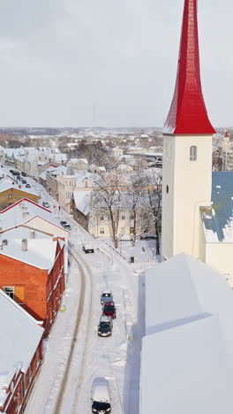 portrait drone shot of snowy streets at the church, winter in rakvere, estonia