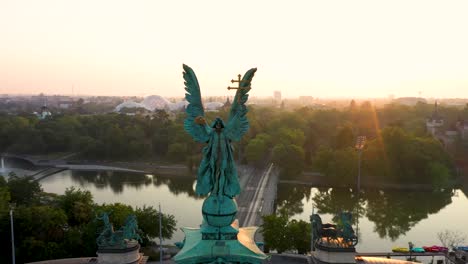 drone footage of the empty heroe's square in budapest, hungary at the time of the covid virus. early morning at the sunrise in spring.
drone circles slowly right around the statue with nice lensflare.