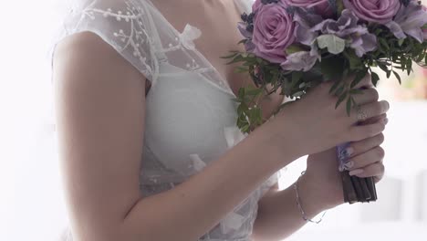 lady hands hold purple rose bouquet slow motion closeup