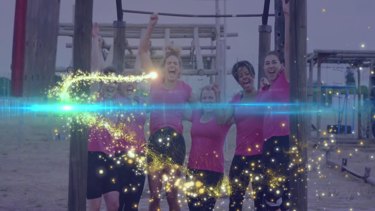 Women in pink shirts celebrating outdoors with sparkling animation overlay