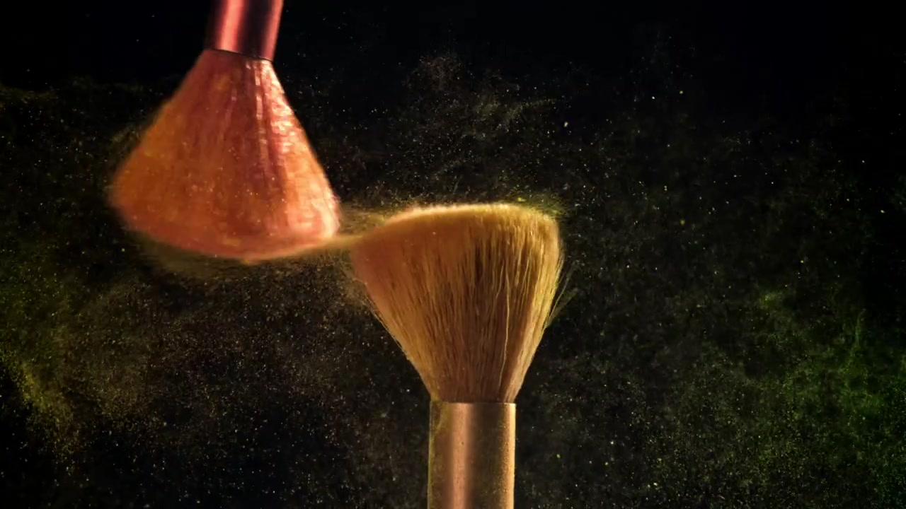 Slow Motion of Makeup Brushes Hitting, Releasing Yellow and Green Cosmetic Powder