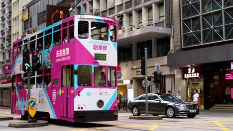 colorful tram travels through busy city streets