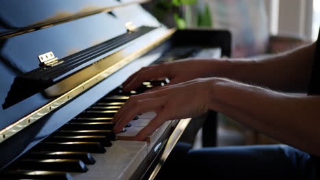 a musician playing the keys and notes of a piano slide right