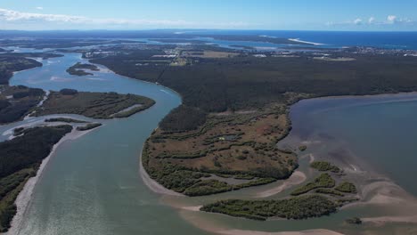 panoramic view of oyster channel flowing in wooloweyah lagoon - yamba, new south wales, australia