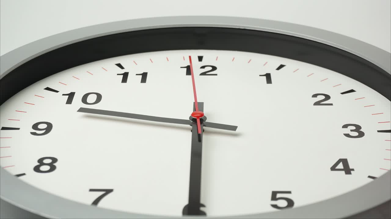 Close-up gray wall clock show running of the time.