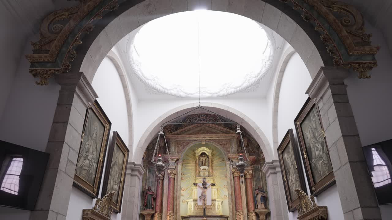 sunlight pours over catholic altar in richly decorated church nave