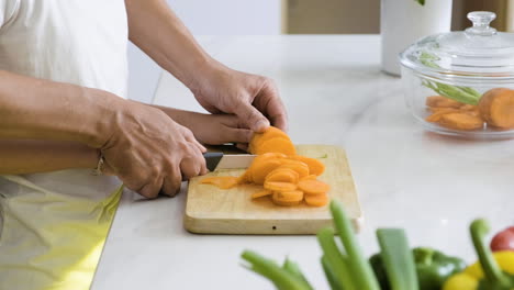 father and daughter cutting carrot.