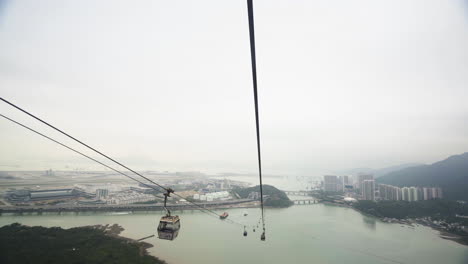 cable car above river and mountains in aerial view