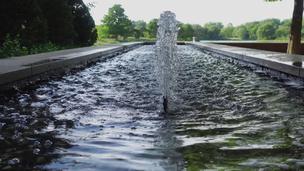 Beautiful long fountain in a summer evening