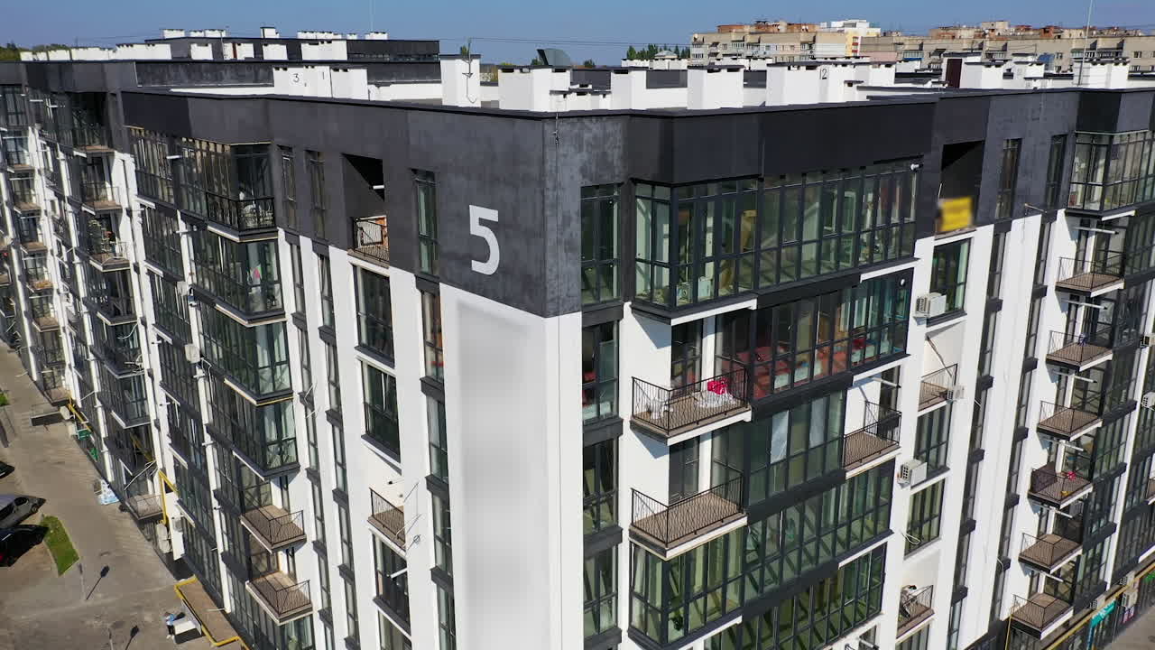 Contemporary residential building in the city. Exterior of a modern design of multistorey apartment building. Aerial view.