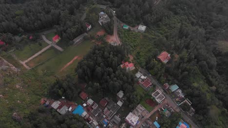 Vista-Aérea-De-Un-Barrio-Remoto-Rodeado-De-Un-Entorno-Natural-De-Bosque-Verde-Fresco,-Concepto-De-Conservación