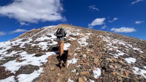 Hiker-with-dog-on-Mount-Lincoln-loop-Kite-Lake-Trail-hiking-14er-Rocky-Mountains-Colorado-dusting-Bross-Cameron-Democrat-Grays-Torreys-Quandary-peaks-fall-first-snow-dusting-blue-sky-follow