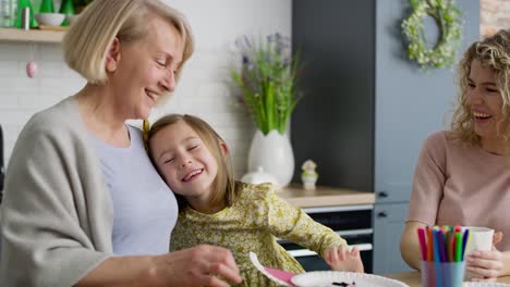 video of cute playful girl hugging her grandmother and mother