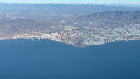 almeria city, spain, panoramic side view shot from a jet cockpit in a left turn at 3000m high in a bright and splendid morning