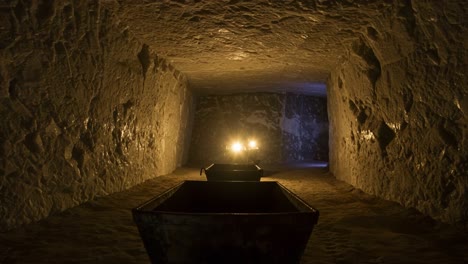 exploring the depths of an abandoned mine: an atmospheric journey through dimly lit tunnels and weathered mine carts highlighted by mysterious lights