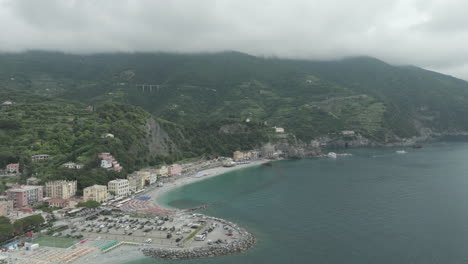 Wide-view-of-Monterosso-al-Mare-on-a-cloudy-day-and-showing-the-Liguria-Sea-in-Italy-with-the-drone-video-moving-forward