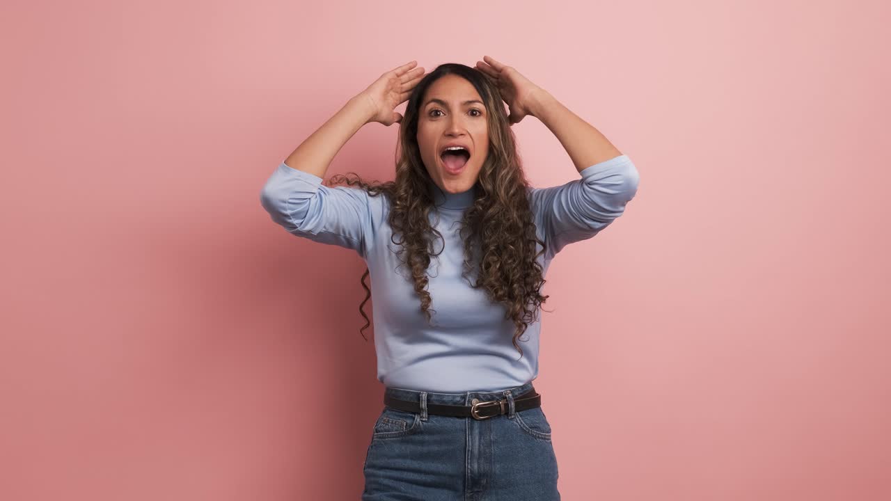 Surprised woman gesturing with mouth open looking at camera