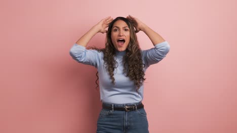 surprised woman gesturing with mouth open looking at camera